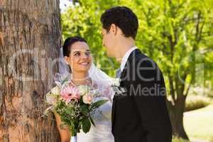 Romantic newlywed couple standing in park