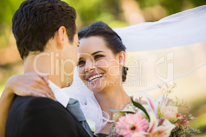 Romantic newlywed looking at each other in park