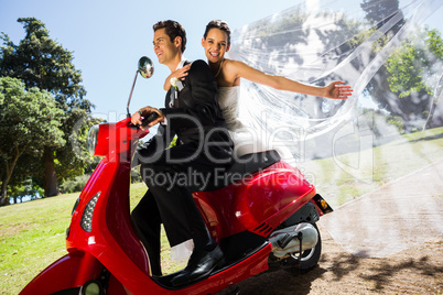 Newlywed couple enjoying scooter ride