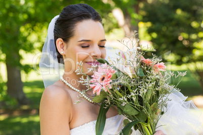 Close-up of a beautiful bride with bouquet in park