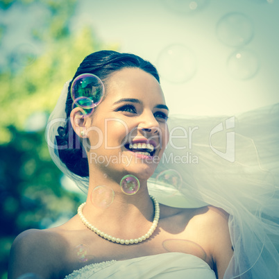 Close-up of beautiful bride looking at soap bubbles