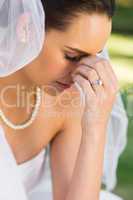 Beautiful worried bride at park