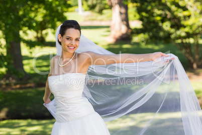 Portrait of a smiling beautiful bride in park
