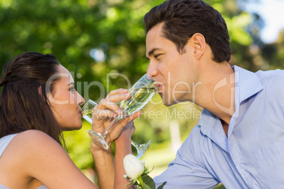 Couple drinking champagne at outdoor cafÃ©