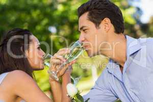 Couple drinking champagne at outdoor cafÃ©