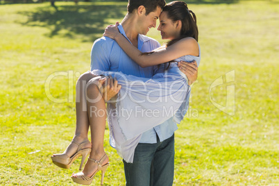 Man carrying a woman in park