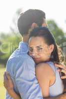 Side view of young couple embracing at park