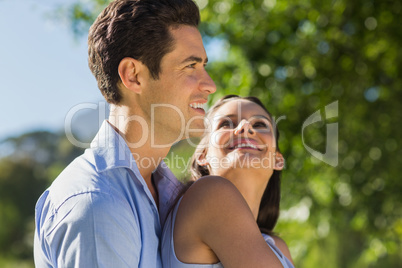 Loving and happy young couple at park