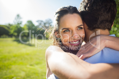 Close-up of a loving woman embracing man at park