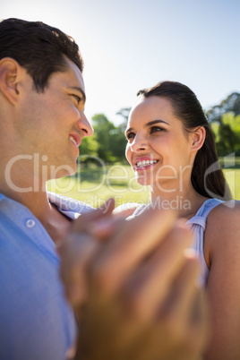 Loving and happy couple dancing at park