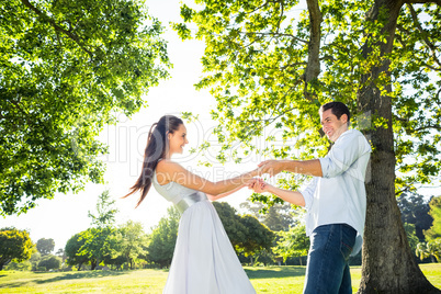 Loving young couple holding hands at park