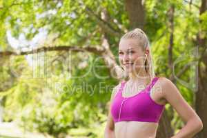 Healthy woman in sports bra jogging in park