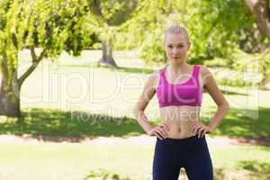 Healthy and beautiful woman in sports bra in park