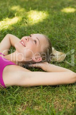 Relaxed beautiful woman lying on grass in park