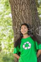 Smiling woman wearing green recycling t-shirt in park