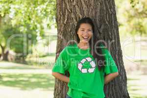 Smiling woman wearing green recycling t-shirt in park