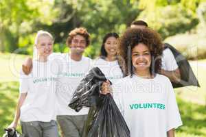 Team of volunteers picking up litter in park