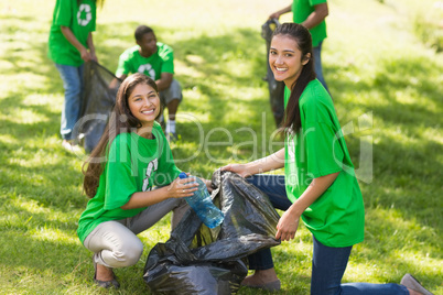 Team of volunteers picking up litter in park