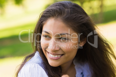 Close-up of a smiling woman looking away in park