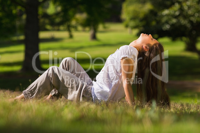 Full length side view of a woman sitting in park