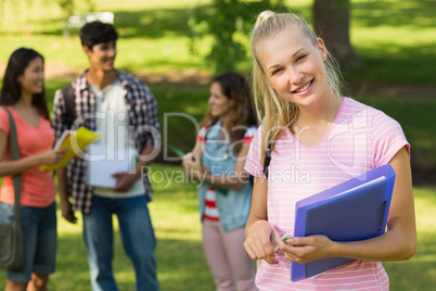 Girl with college friends in background at campus