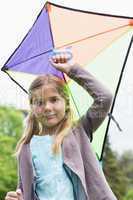 Portrait of cute young girl with a kite