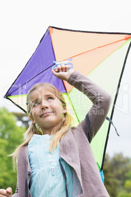 Low angle view of cute girl with a kite