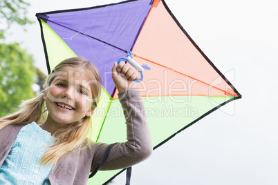 Portrait of a cute girl with a kite