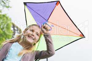 Low angle view of a cute girl with a kite