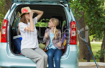 Mother and daughter in car trunk