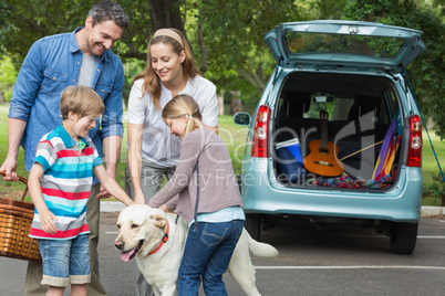 Family with kids and pet dog at picnic