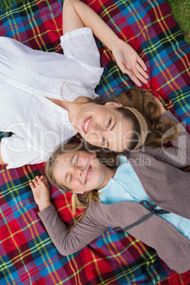Elevated view of mother and daughter lying at park