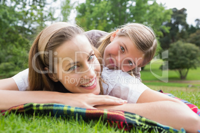 Happy mother with daughter lying at park