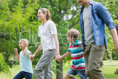 Parents and kids walking in park