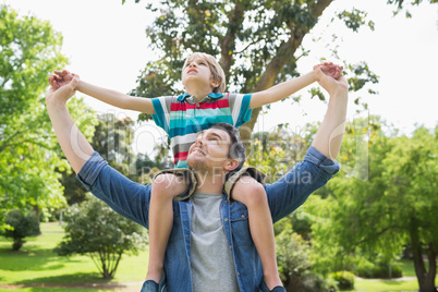 Father carrying boy on shoulders