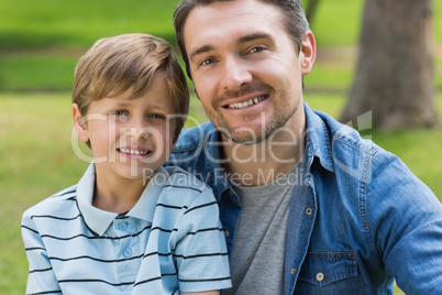 Close-up portrait of father and boy at park