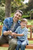 Portrait of a smiling father and son fishing