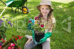 Smiling young girl engaged in gardening
