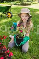 Smiling girl engaged in gardening