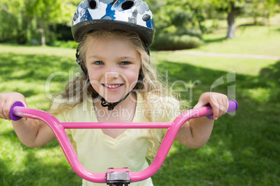 Close-up of little girl on a bicycle at park