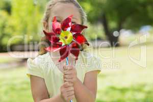 Cute girl holding pinwheel at park