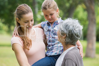 Grandmother mother and daughter at park