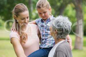 Grandmother mother and daughter at park