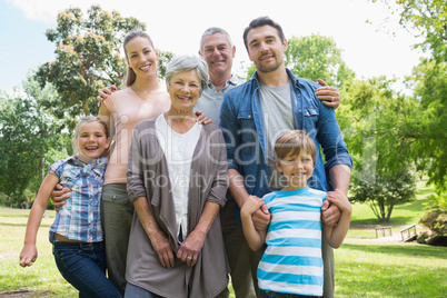 Happy extended family standing at park