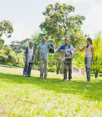 Happy extended family walking in park