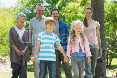 Happy extended family standing at park