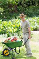 Mappy male gardening with wheelbarrow at garden