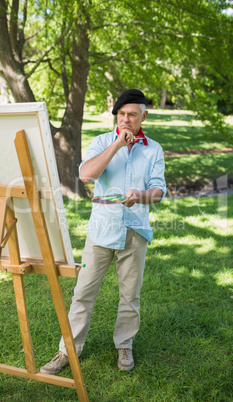 Full length of a mature man painting in park