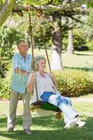 Mature couple at swing in park