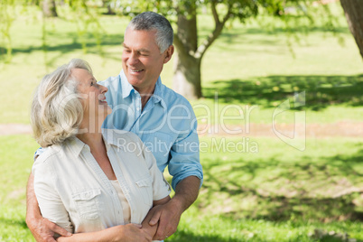 Loving and happy mature couple at park